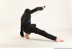 Man Young Athletic Fighting with knife Kneeling poses Casual Asian